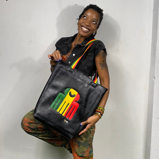 black leatherette tote bag with duafe adinkra symbol in rasta colors handmade in jamaica. laptop compartment, long straps and padded body. 